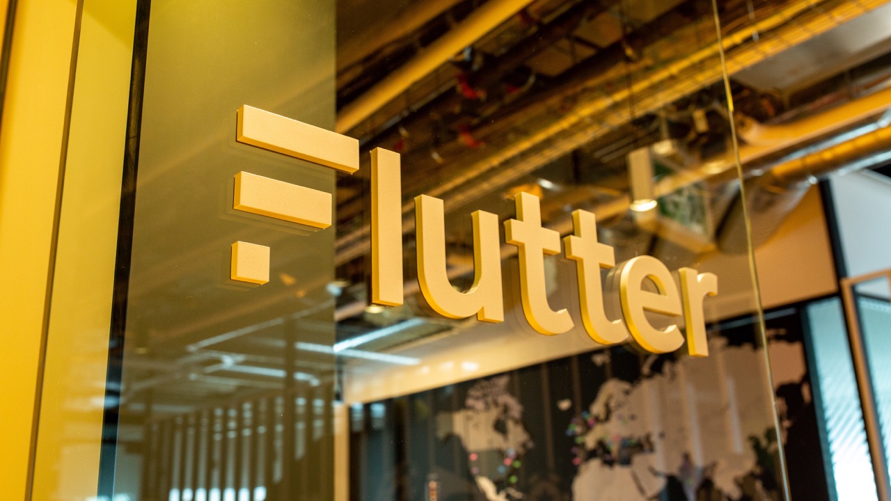 Flutter Entertainment name mounted on a glass office wall